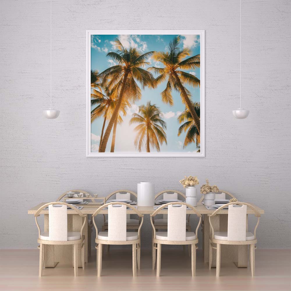WanderNest's Caribbean travel photo featuring tall tropical palm trees with golden sunlight filtering through the fronds against a bright blue sky. A serene, nature-inspired beach scene perfect for coastal, boho, or summer-themed decor. High-resolution printable digital wall art designed to bring a warm, tropical vibe to any space—ideal for beach houses, vacation rentals, living rooms, bedrooms, or kitchens. Instant download for easy home decor refresh with a sunny, vacation-style, relaxation aesthetic.