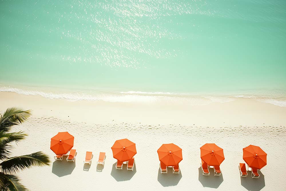 WanderNest's high-resolution digital wall art photography featuring a tranquil aerial view of a tropical beach with soft white sand, gentle ocean waves, and crystal-clear turquoise water. Five vibrant orange beach umbrellas with matching lounge chairs are neatly arranged along the shore, creating a minimalist and modern coastal scene. Perfect for summer decor, beach-themed interiors, or vacation home wall art. Printable digital download ideal for instant decor refresh.